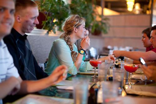 Adults eating at local eatery